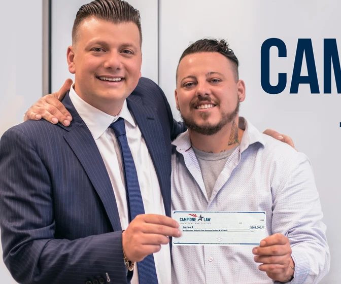Chris with James R. holding his check, as published by Campione Law