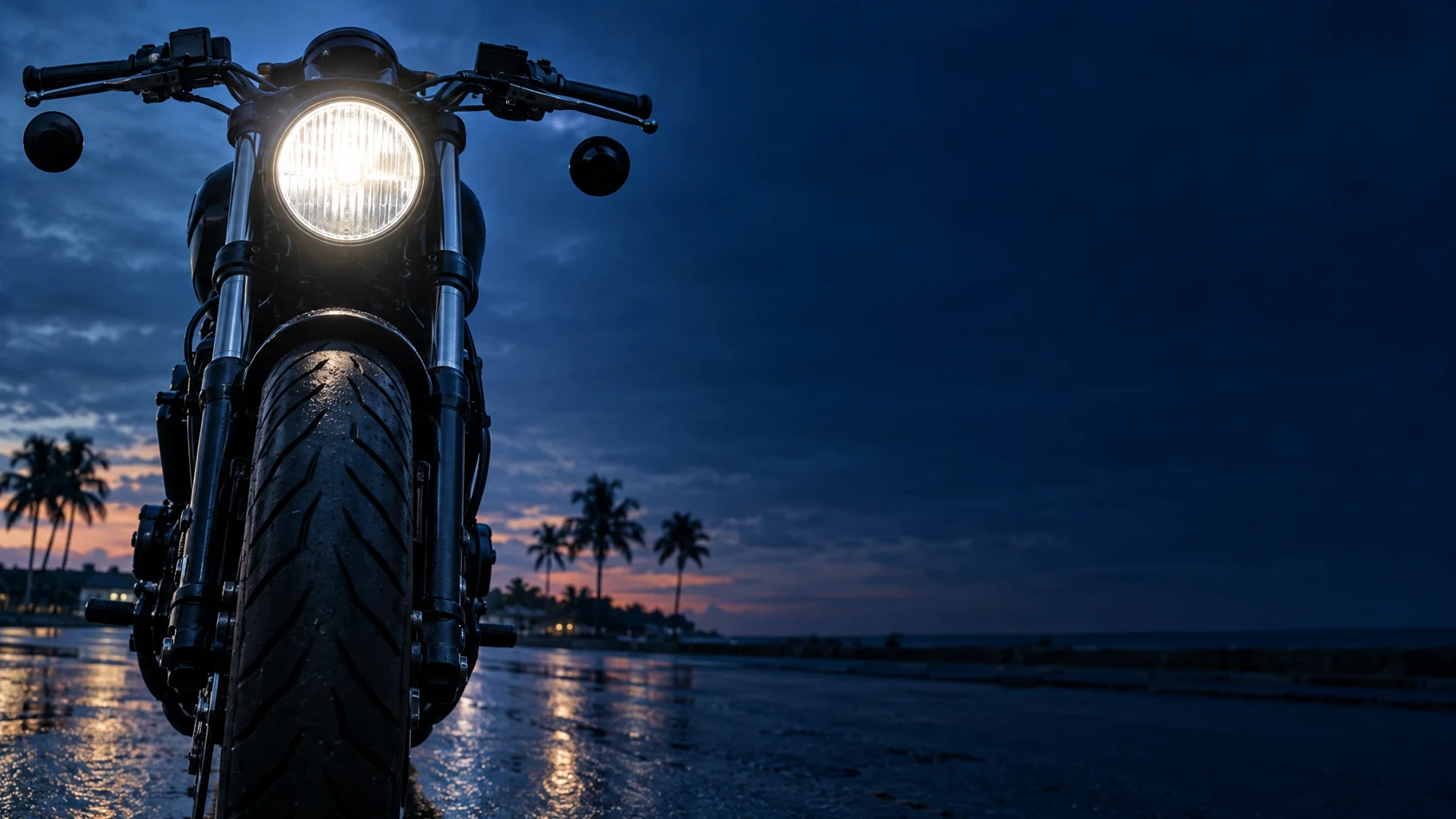 Black motorcycle with its headlight illuminated beside a Florida road